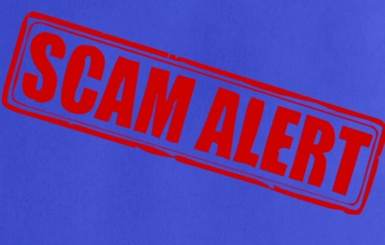 Red "SCAM ALERT" stamp on a blue background